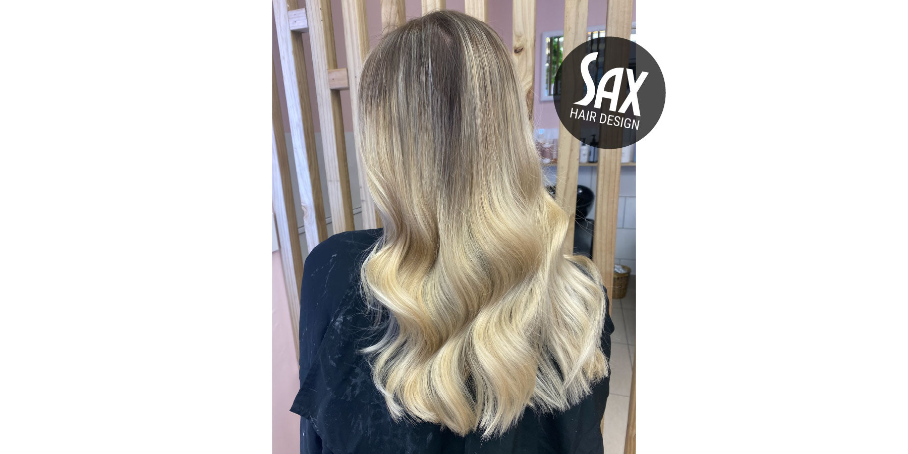 Photo of client with long blonde balayage hair, after appointment at Sax Hair Design.