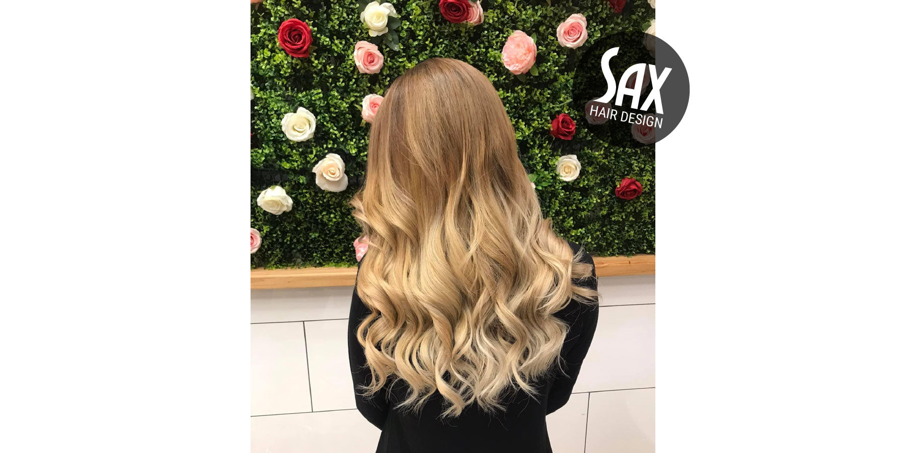 Photo of client with long blonde balayage hair, after appointment at Sax Hair Design.