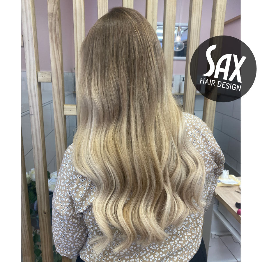 Photo of client with long blonde balayage hair, after appointment at Sax Hair Design.