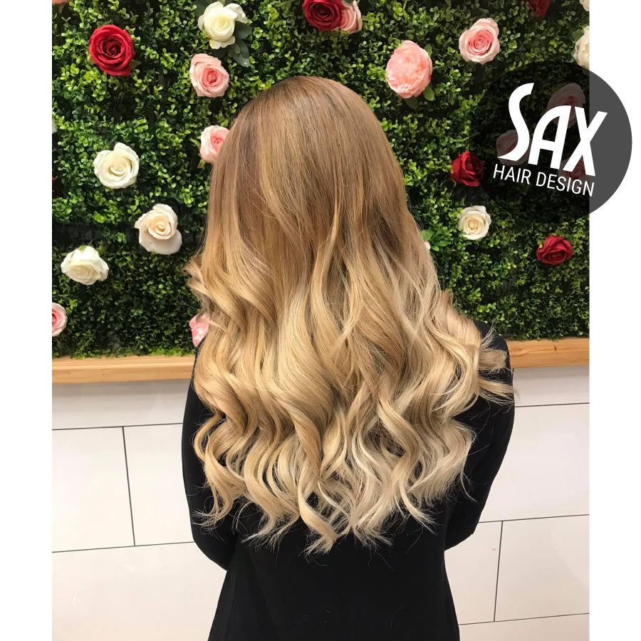 Photo of client with long blonde balayage hair, after appointment at Sax Hair Design.